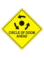 A yellow caution diamond with a roundabout symbol and the words Circle of Doom Ahead