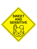 A yellow caution diamond with a picture of a smiling bunny face with the words Sweet and Sensitive